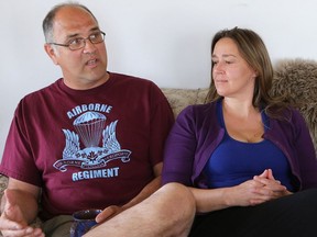 Dave Bona speaks about his experience in the armed forces suffering from the side-effects of an anti-malaria drug with his partner Teresa Untereiner and dog Aras by his side at his home in St. Denis on May 17, 2016. (Michelle Berg / Saskatoon StarPhoenix)