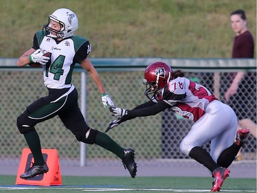 Saskatoon Valkyries' Julene Friesen dodges Regina Riot's Nikki Broom to score a touchdown during women's tackle football action at SMF Field in Saskatoon on May 22, 2016.