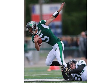 South's Shawn Nixon gets pulled to the ground by North's Kenneth Wiebe during 6 Man Ed Henick Senior Bowl action at SMF Field in Saskatoon on May 23, 2016.
