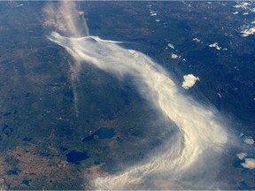 A handout picture released on May 9, 2016 by ESA/NASA agencies shows a view of smoke from wildfires in Fort McMurray taken from the International Space Station for Expedition.