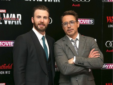 Actors Chris Evans (L) and Robert Downey Jr. pose for photographers upon arrival at the European premiere of "Captain America: Civil War" in London, England, April 26, 2016.