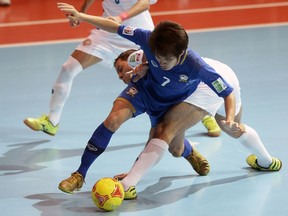 Costa Rica's Michael Cordoba (back) vies with Thailand's Kritsada Wongkaeo (front) during their 2012 group A match at the FIFA Futsal World Cup.