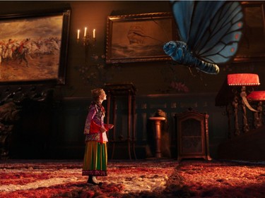 Mia Wasikowska as Alice and Absolem, voiced by Alan Rickman, in "Alice Through The Looking Glass."