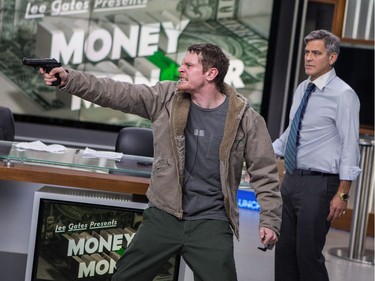 Jack O'Connell as Kyle Budwell (L) and George Clooney as Lee Gates in TriStar Pictures' "Money Monster."