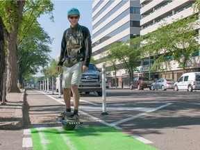 Jonathan Storey enjoys the new bike lane on Fourth Avenure while commuting to work on his "Onewheel" electric skateboard. The new lanes will encourage people to use alternative forms of transportation, he said.