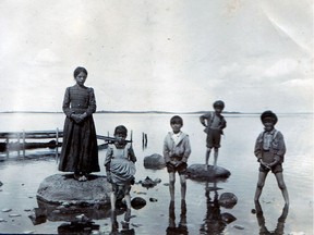 Kids playing in the water at Ile-a-la-Crosse. (photo by Louis Cochin, courtesy Rene Charpentier)