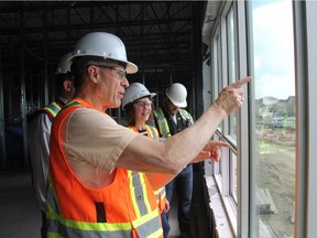 Saskatchewan Education Minister Don Morgan looks out of the window towards the site of future play spaces from the second floor of the new joint-use school in Saskatoon's Stonebridge neighbourhood. According to construction officials, all 18 of the P3 schools are on time and on budget, and it's welcome news for the Ministry of Education.