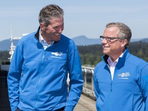 Premier Brad Wall with Manitoba's Brian Pallister, who was elected  under more stringent political fundraising rules.