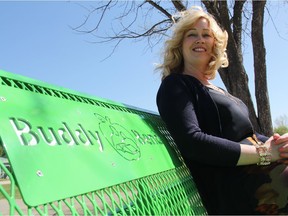 Miranda Low, the principal at Montgomery School, sits on her school's buddy bench installed at the school on April 29, 2016. Low said while the bench has only been in place for a short while, kids were quick to take to the idea and have already embraced it. (Morgan Modjeski/The Saskatoon StarPhoenix)