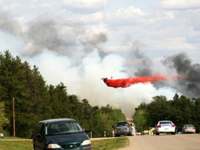 An aircraft drops fire retardant on a forest fire just north of Prince Albert in 2010. (Prince Albert Daily Herald)