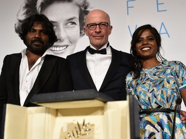 L-R: Actor Jesuthasan Antonythasan, director Jacques Audiard and actor Kalieaswari Srinivasan pose with Palme d'Or won for "Dheepan" during the Palme D'Or Winners press conference during the 68th annual Cannes Film Festival on May 24, 2015 in Cannes, France.