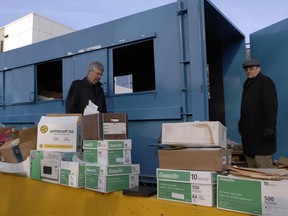 In this March 23, 2011 file photo, Saskatchewan information and privacy commissioner Gary Dickson (left) and NDP MLA Kevin Yates remove medical files from a recycle bin south of the Golden Mile mall in Regina