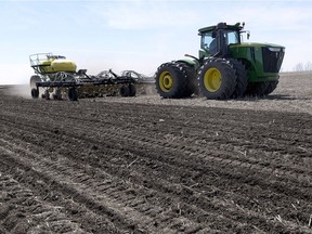 Faron and Patricia Jones seeding barley in a field near Edgeley in late April.