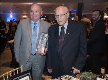 Former University of Saskatchewan professor Charles "Red" Williams (R, with Phil Klein of the Royal Bank) was inducted into the SABEX Hall of Fame at the SABEX Awards at Prairieland Park on May 19, 2016.