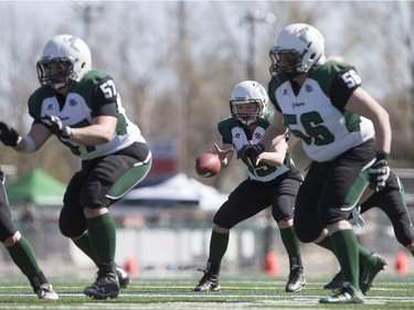 Saskatoon Valkyries quarterback Alex Eyolfson grabs the snap against the Edmonton Storm during a Western Women's Canadian Football League (WWCFL) exhibition game at SMF field, April 30, 2016