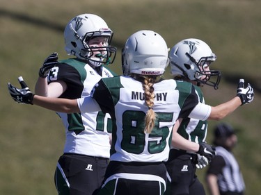 Saskatoon Valkyries receiver Alyssa Wiebe, left #13, and receiver Kelsey Murphy, #85, celebrate a touchdown against the Edmonton Storm during a Western Women's Canadian Football League (WWCFL) exhibition game at SMF field on Saturday, April 30, 2016.