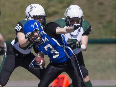 Saskatoon Valkyries defensive linemen Bestsy Mawdsley, left #90, and linebacker Beth Thomson, #2, tackle a Edmonton Storm player during a Western Women's Canadian Football League (WWCFL) exhibition game at SMF field on Saturday, April 30, 2016