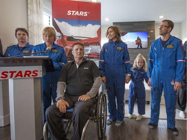 Survivor Jason Simpson (3L), who was a STARS patient, takes part in the STARS annual Lottery launch at the Grand Prize show home at 104 Greenbryre Crescent North in Saskatoon, May 12, 2016.