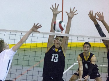 Jake Gomes, U17 player for Pakmen Black from Mississauga Ontario, gets his arms together for the block against the Samurai from Quebec at the U17/U18 Volleyball Championships in Saskatoon,  May 13, 2016.