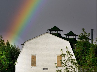 A magnificent rainbow jumped out of the dark eastern rain cloud sky and was played up against a barn on the University of Saskatchewan grounds, May 17, 2016.