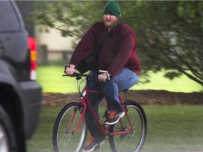 A cyclist is caught in the rinse cycle, or a down pour that occurred over the supper hour in Saskatoon, May 24, 2016