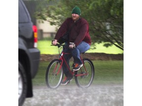 A cyclist is caught in a downpour that occurred over the supper hour in Saskatoon, May 24, 2016.