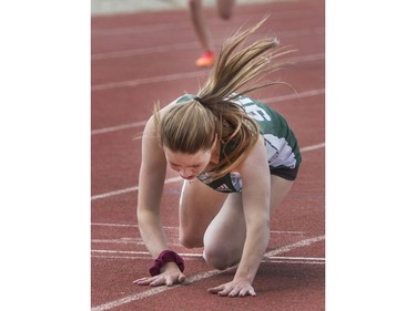 Ensley Fendelet feeling sick, falls at the finish line in the midget girls 400-metre heat at the Saskatoon High School Track and Field city championships at Griffith Stadium, May 25, 2016.