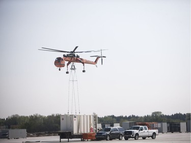 A helicopter crane lifts cargo onto the roof of the new Bus Barn near the Saskatoon Landfill in Saskatoon, May 14, 2016.