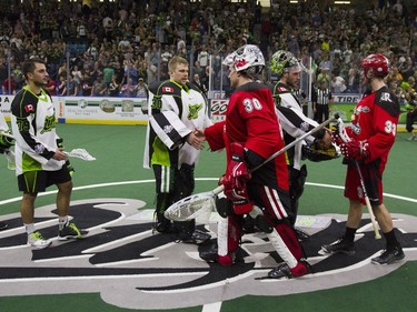 Saskatchewan Rush goalie #30 Tyler Carlson #30 (CL) shakes hands with Calgary Roughnecks goalie #30 Mike Poulin (CR) after a 12-9 win for the Rush at SaskTel Centre in Saskatoon, May 21, 2016.