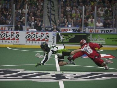 Saskatchewan Rush #74 Jeremy Thompson (L) takes a dive after colliding with Calgary Roughnecks defence #16 Mike Carnegie at SaskTel Centre in Saskatoon, May 21, 2016.