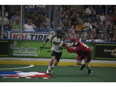 Saskatchewan Rush #33 John LaFontaine (L) attempts to move past Calgary Roughnecks defence #52 Kellen Leclair during the game at SaskTel Centre in Saskatoon, May 21, 2016.
