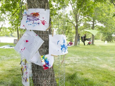 Children's paintings hang on a tree during the Pop-up Playground in Victoria Park, May 28, 2016. This playground is to help children focus on the natural work in Saskatoon.