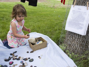 Miranda Leson plays with rocks at the Rock stories area at the Pop-up Playground in Victoria Park, May 28, 2016. This playground is to help children focus on the natural work in Saskatoon.