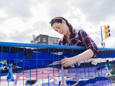 Wendy, a local artist, builds an installation to "beautify Broadway" during the Broadway Art Festival in Saskatoon, May 28, 2016.