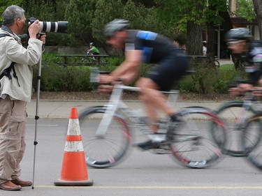 Cyclists speed by a photographer during the category 1 and 2 race at Bikes on Broadway in downtown Saskatoon on May 22, 2016.