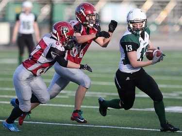 Saskatoon Valkyries' Alyssa Wiebe runs with the ball against the Regina Riot in women's tackle football action at SMF Field in Saskatoon on May 22, 2016.