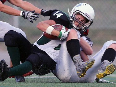 Saskatoon Valkyries' Julene Friesen gets tackled during women's tackle football action at SMF Field in Saskatoon on May 22, 2016.