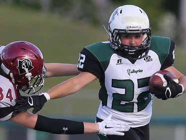 Saskatoon Valkyries' Samantha Matheson dodges Regina Riot's Katie Hungle in women's tackle football action at SMF Field in Saskatoon on May 22, 2016.