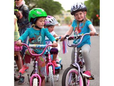 Young cyclists Tové Lawrence (L) and Zoey Coller get ready to race at Bikes on Broadway in downtown Saskatoon on May 22, 2016.