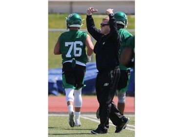 Coach Chris Jones speaks to players during day one of Riders training camp at Griffiths Stadium in Saskatoon, May 29, 2016.