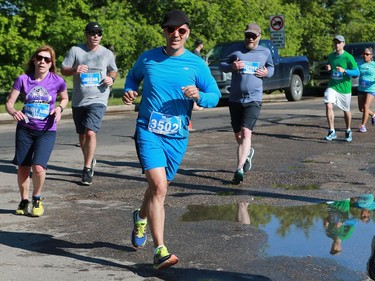 Osemis Isbister Bear runs the 10km at the Saskatchewan Marathon at Deifenbaker Park in Saskatoon on May 29, 2016.