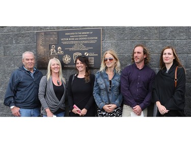 Family members of Victor Budz and Dennis Guenter stand in front of the plaque honouring  them outside the Scotiabank Theatre in Saskatoon. The two lost their lives while fighting a fire at the Queen's Hotel on May 31, 1980 .