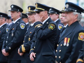 The Saskatoon Fire Fighters IAFF Local 80 honour Victor Budz and Dennis Guenter who lost their lives while fighting a fire at the Queen's Hotel fire on May 31st 1980 with a plaque on the building at the site of the Queen's Hotel, currently the Scotiabank Theatre & Cineplex VIP in Saskatoon on May 31, 2016.