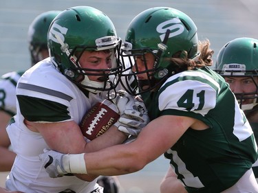 U of S Huskies' Colton Klassen protects the ball from Vince Greco during first half action to close out their spring camp at Griffith's Stadium on May 8, 2016.