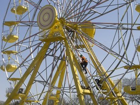 Access 2000 employee Nick Cooper climbs to the hub of the ferris wheel in PotashCorp Playland at Kinsmen Park, Tuesday, May 03, 2016, to service the machinery.