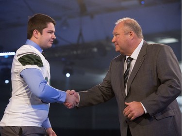 Recruit Chase Klassen of Saskatoon is welcomed by Huskies head coach Brian Towriss during the annual Huskies Dog's Breakfast event at Prairieland Park, May 5, 2016.