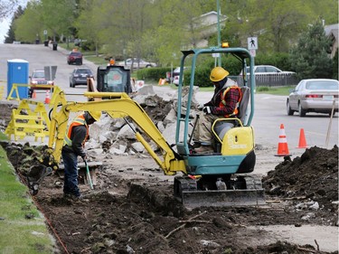 Workers from RN Concrete repair the sidewalks on Pinehouse Drive, May 12, 2016.