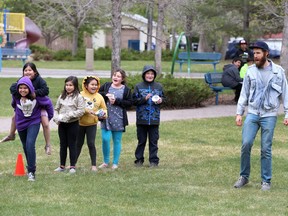 Sum Theatre artistic director Joel Bernbaum motivates students from St. Frances School in a relay race to announce the new Theatre in the Park show Little Badger & the Fire Spirit.