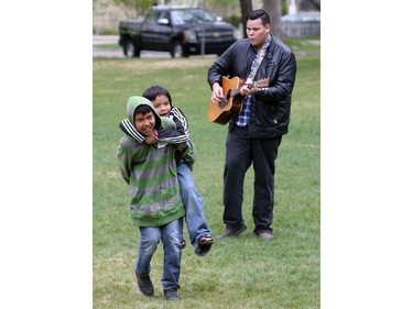 SUM Theatre kicked off its Theatre in the Park season with a fun relay event in Thornton Park involving school kids from St. Frances school, May 12, 2016. The event was in celebration of the new production called Little Badger and The Fire Spirit. Here Sum musician Lancelot Knight plays for students in the piggyback race.