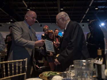 Charles Williams (R) is given an award as he is inducted into the 2016 Business Hall of Fame at the SABEX awards at Prairieland Park in Saskatoon, May 19, 2016.
